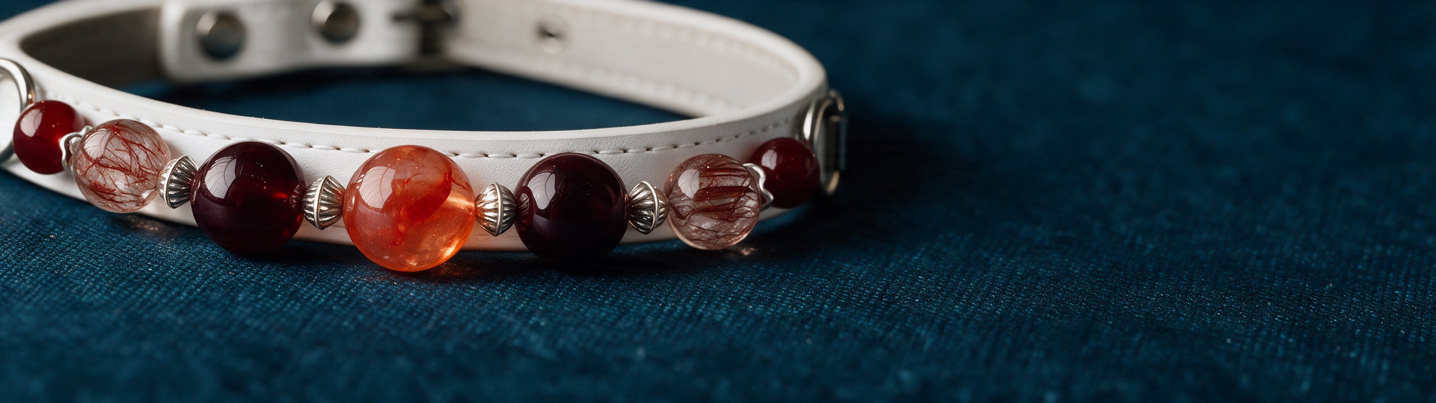 A close view of the smooth round red and clear beads on Ember Bond