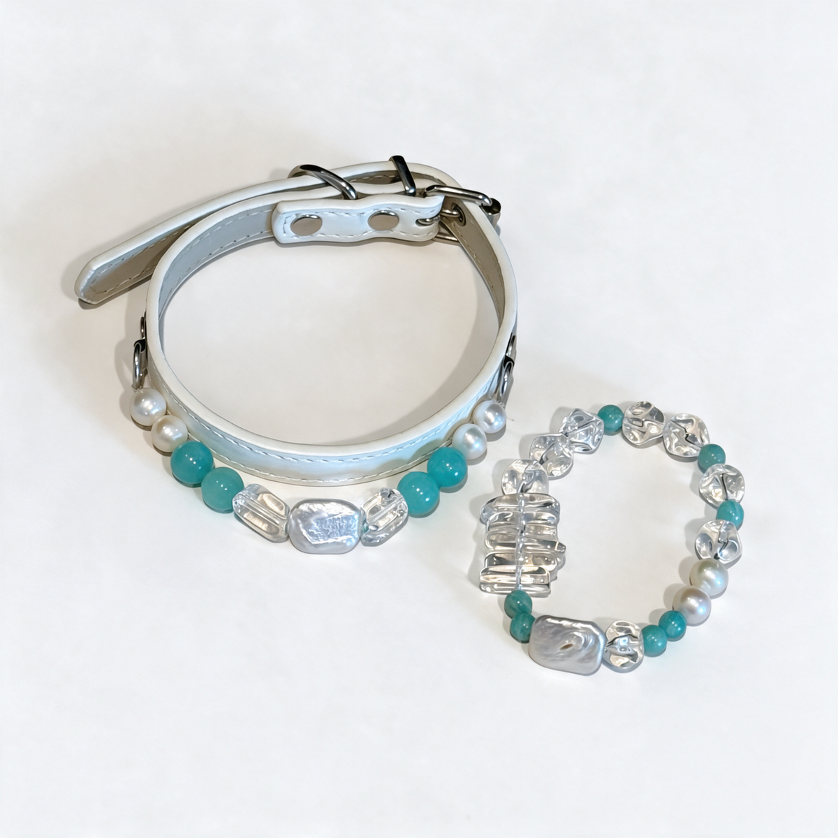 Lagoon Treasure matching pet jewelry and owner bracelet — studio view. AI-styled imagery based on this design.