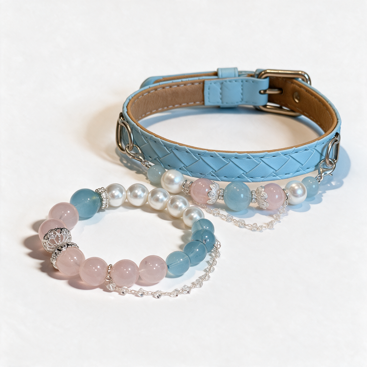 Coastal Blush matching set with a light-blue pet collar and a coordinating pink, blue and pearl-like bead bracelet on a white background.