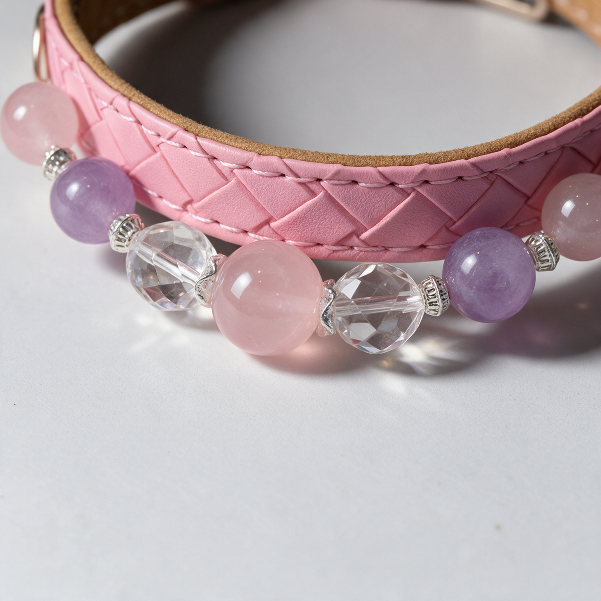 Close view of the Lilac Blush collar, showing pink and lavender-toned beads, clear faceted details and a pink diamond-stitched band.
