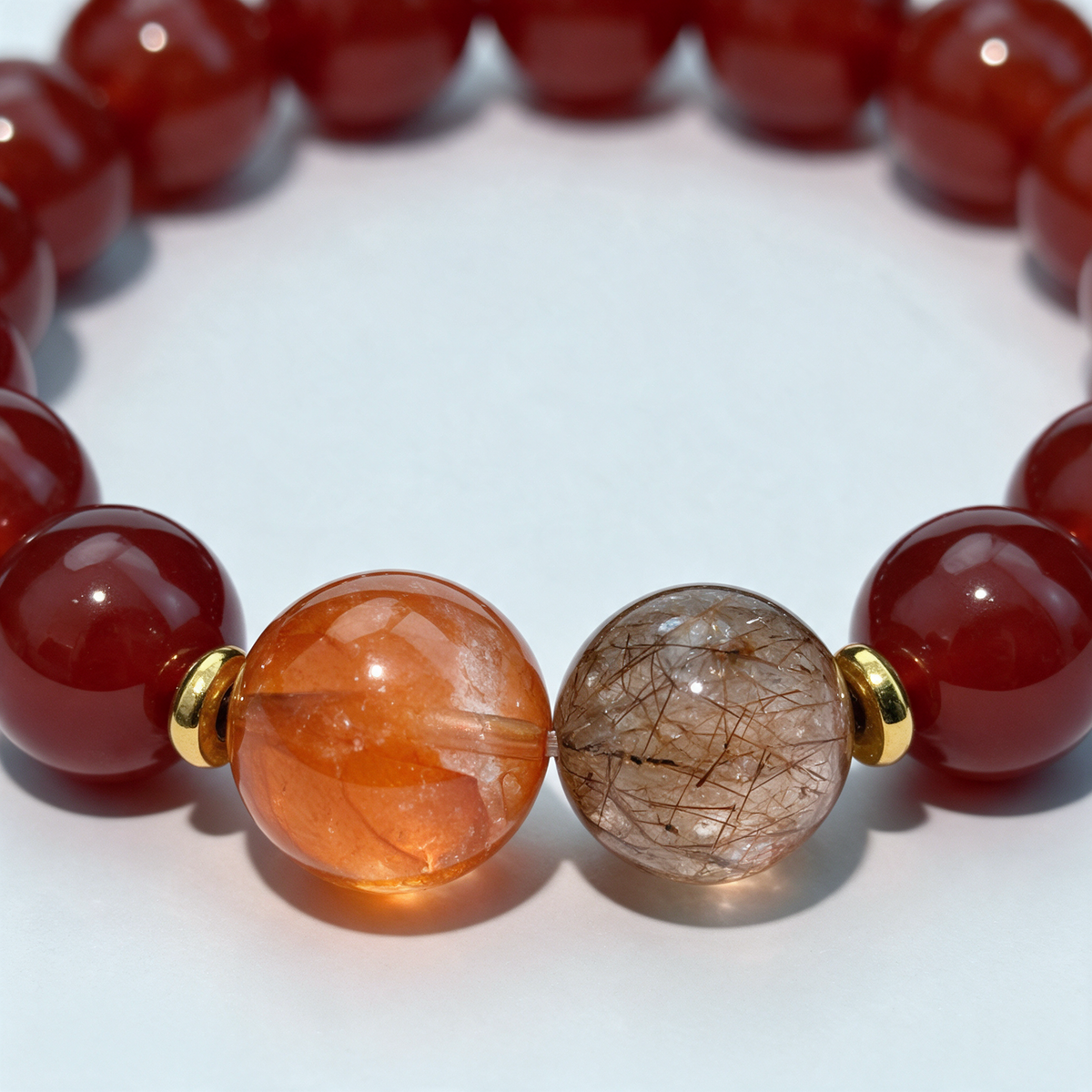 Close view of the Ember Together bracelet’s adjacent orange and brown inclusion beads and red accents.