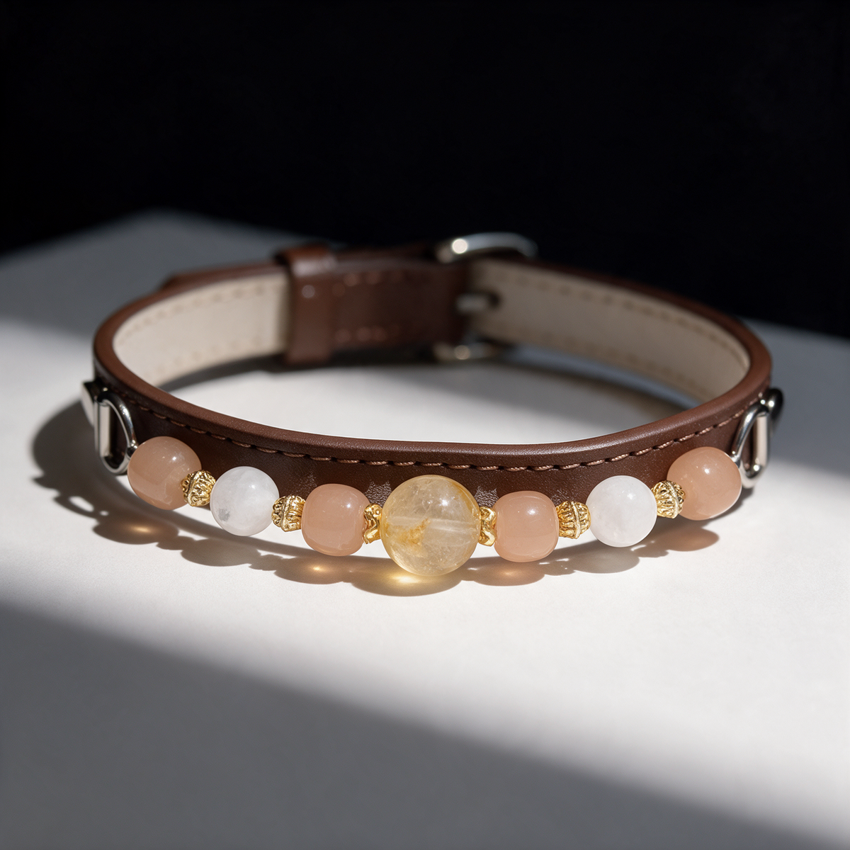 Close view of the Apricot Keepsake collar, showing its yellow focal bead, pale-pink barrel beads, white beads and gold-tone fittings.