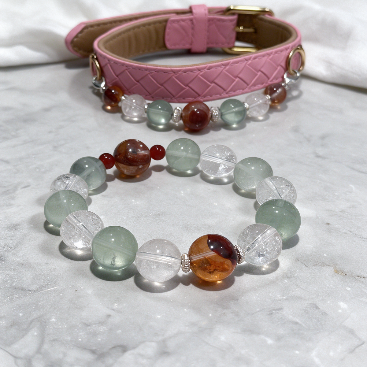 Close-up of the Garden Ember matching dog collar and owner bracelet, showing bead textures, metal accents and the pink quilted band.