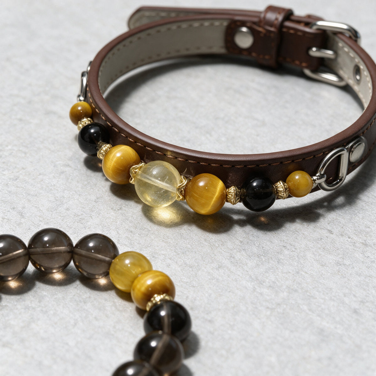 Close-up of the Golden Hour collar and matching bracelet, showing the beads, separators and stitched brown band.