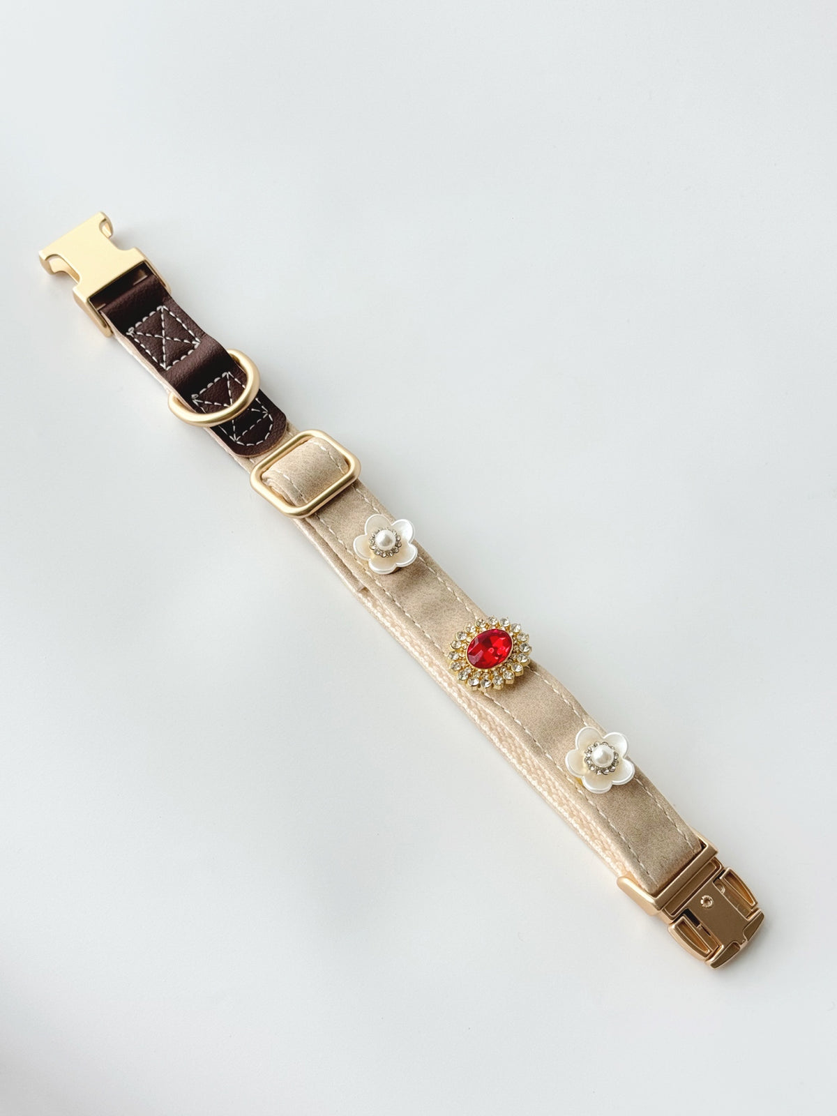S/M cream buckle collar styled with three charms. Every size includes five selectable charms; extra charms and leash sold separately.