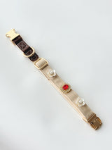 S/M cream buckle collar styled with three charms. Every size includes five selectable charms; extra charms and leash sold separately.