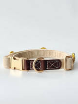 Cream buckle collar hardware detail. Every size includes five selectable charms; extra charms and leash sold separately.