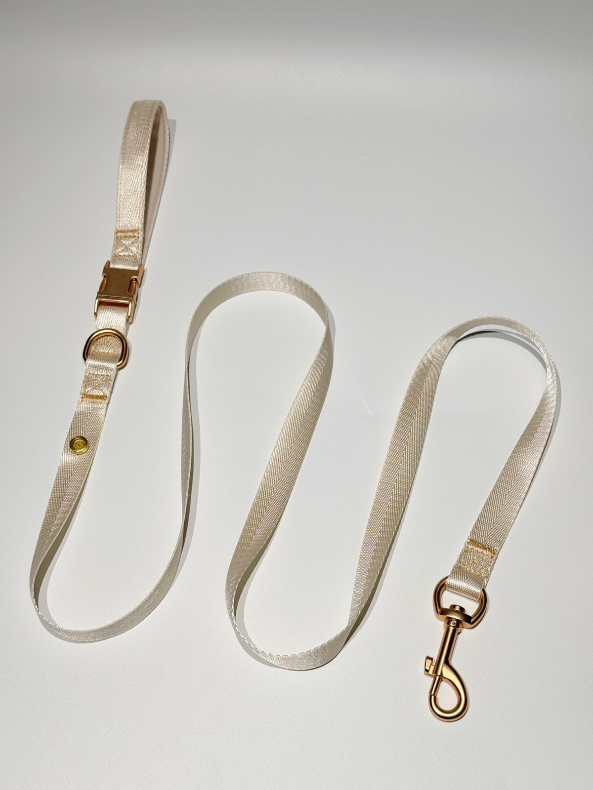 Cream coordinating leash; decorative charms sold separately.