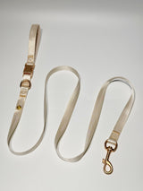 Cream coordinating leash; decorative charms sold separately.